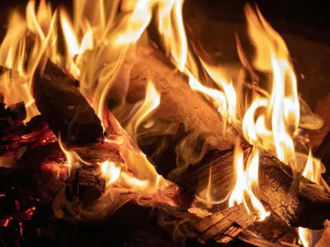 Split logs burning with yellow and orange flames